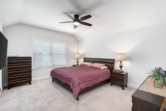 bedroom with ceiling fan, lofted ceiling, and light colored carpet