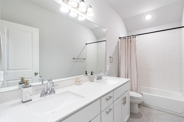 full bathroom featuring lofted ceiling, vanity, shower / bath combination with curtain, tile patterned floors, and toilet