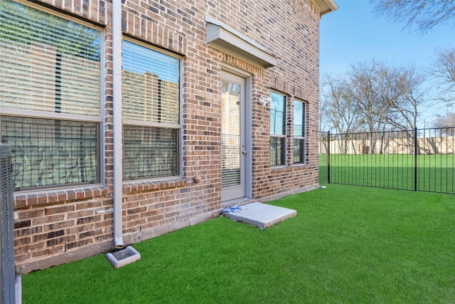 view of exterior entry featuring a yard