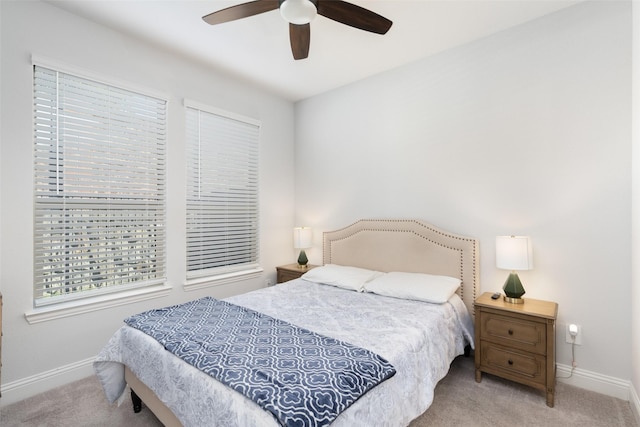 bedroom with ceiling fan and light colored carpet