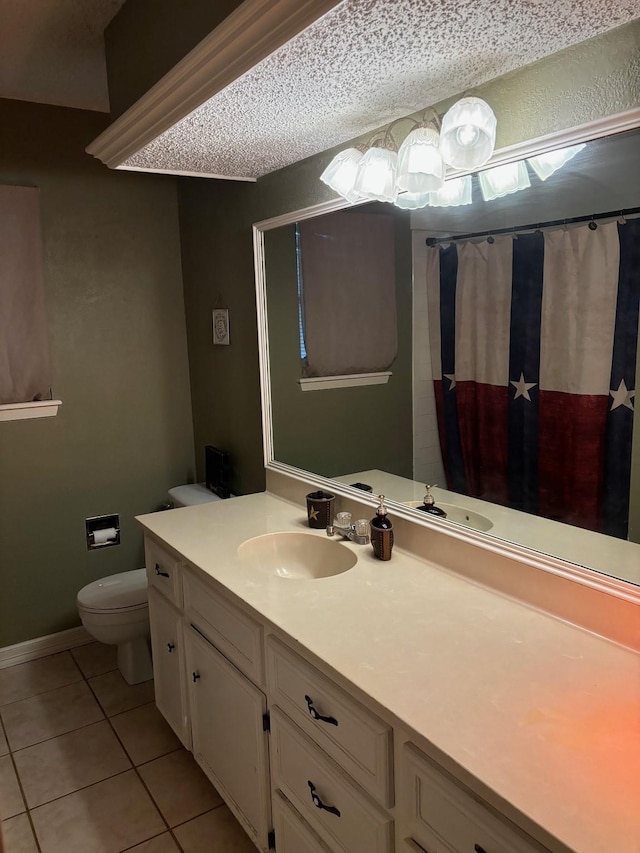 bathroom with vanity, a textured ceiling, tile patterned floors, and toilet