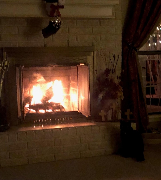 exterior details featuring a brick fireplace