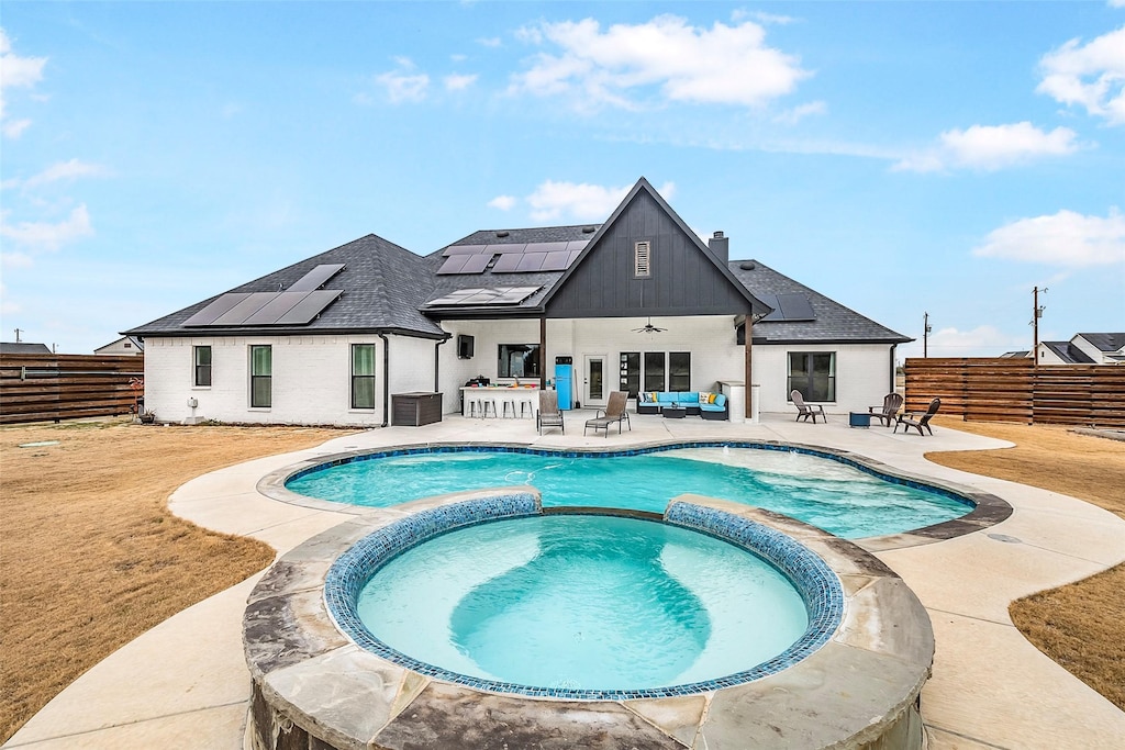 view of pool with an in ground hot tub, ceiling fan, outdoor lounge area, and a patio area