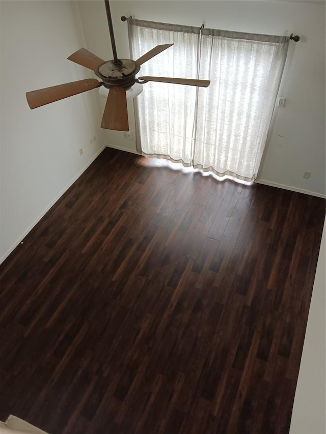 330 W Harwood Rd Unit C, Hurst, TX 76054 - empty room with ceiling fan, dark wood-style floors, and baseboards