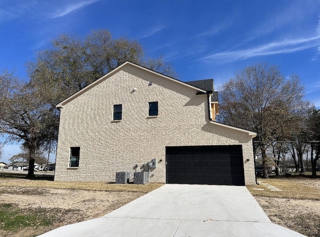 view of side of property with a garage and central AC unit