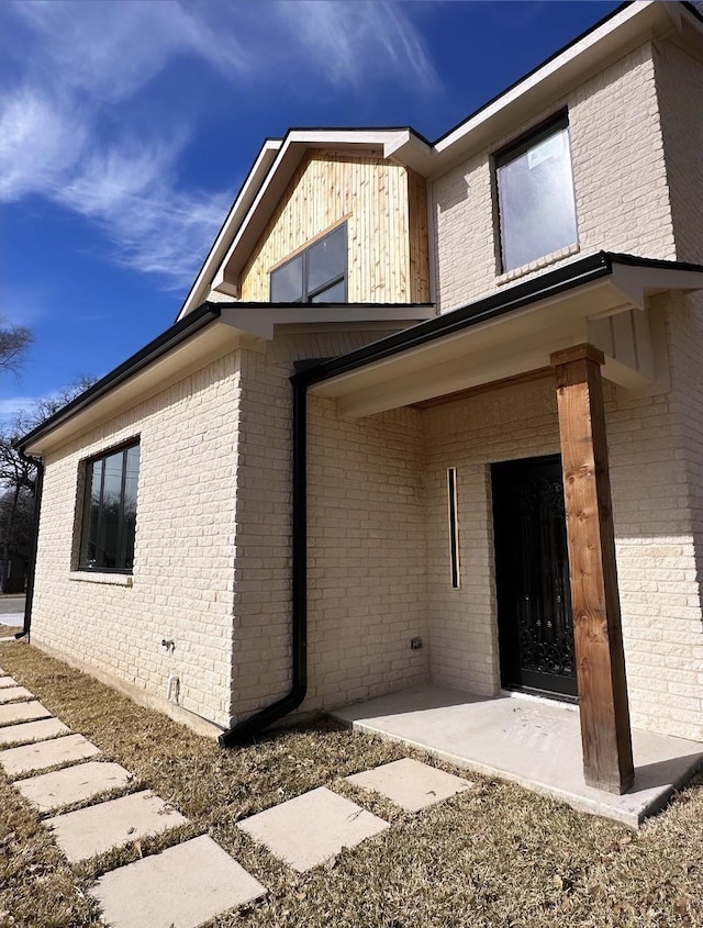 view of side of home with a patio area