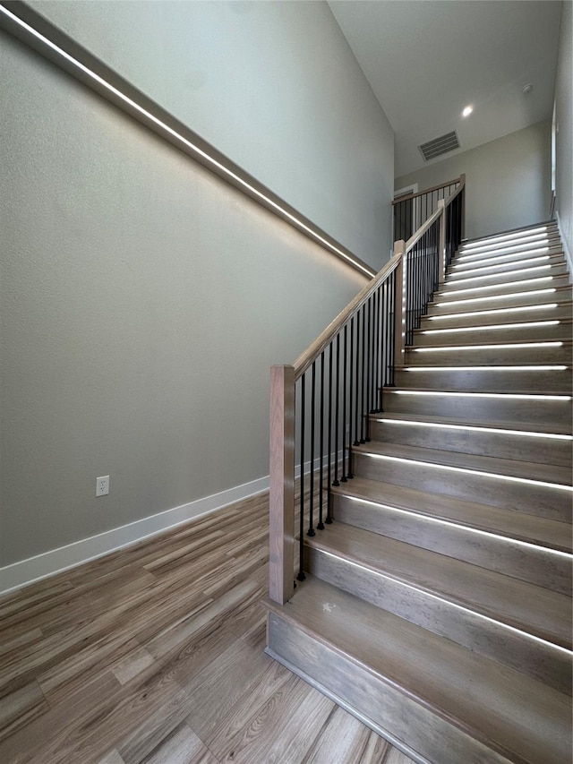 stairway featuring wood-type flooring