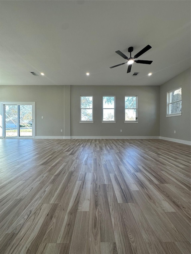 empty room featuring ceiling fan and light wood-type flooring