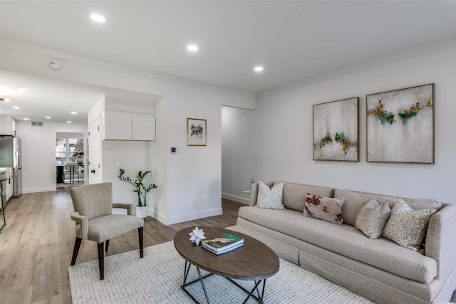 living room featuring crown molding and hardwood / wood-style flooring