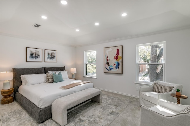 bedroom with ornamental molding and light carpet