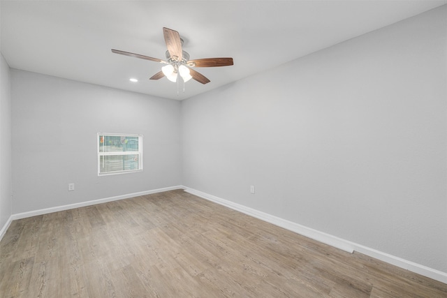 empty room with ceiling fan and light hardwood / wood-style floors