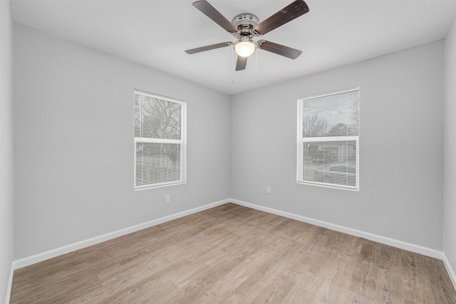 unfurnished room with a healthy amount of sunlight, ceiling fan, and light hardwood / wood-style flooring