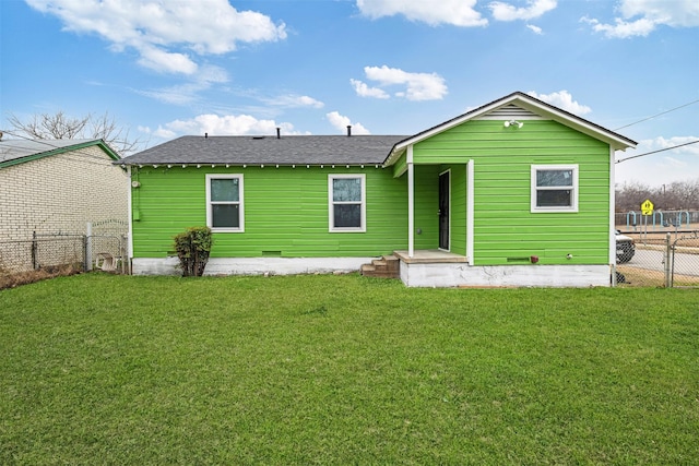 rear view of property with a lawn