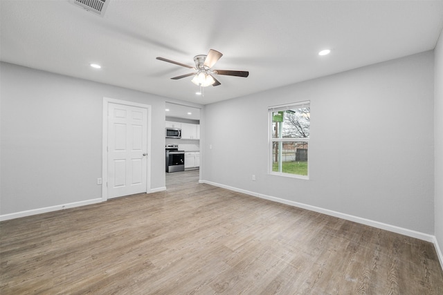 unfurnished living room with ceiling fan and light hardwood / wood-style floors