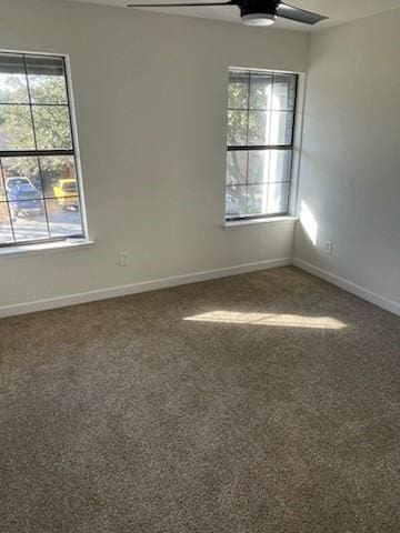 empty room featuring ceiling fan and carpet floors