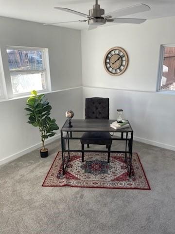 carpeted home office featuring ceiling fan