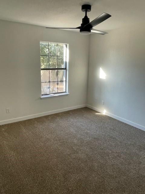 empty room with ceiling fan and carpet flooring