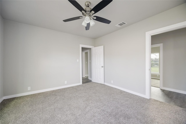 carpeted empty room with ceiling fan