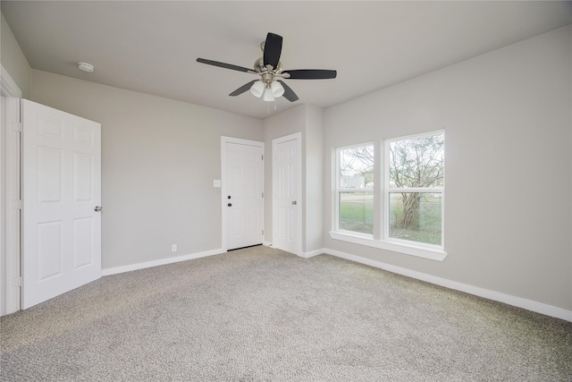 unfurnished bedroom with ceiling fan and carpet