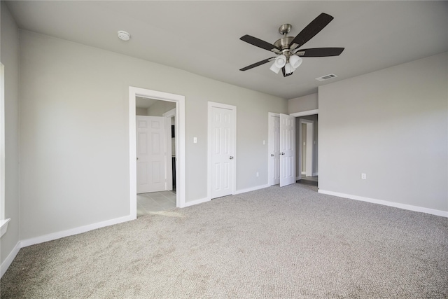 unfurnished bedroom featuring light carpet and ceiling fan