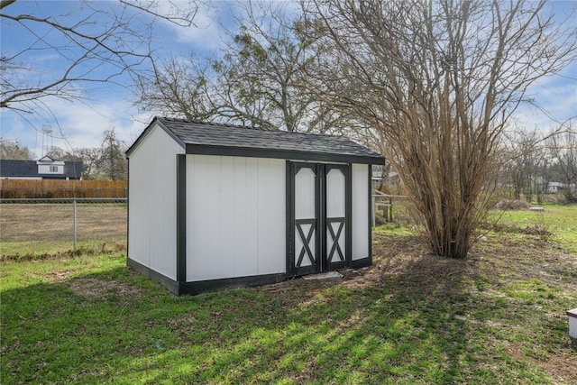 view of outdoor structure featuring a lawn