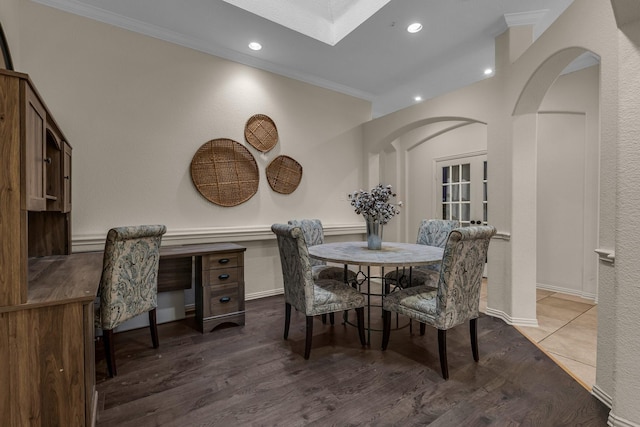 dining space with crown molding and wood-type flooring