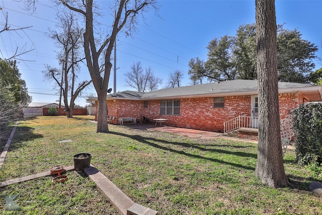 120 N 15th Ave, Munday, TX 76371 - rear view of house with a yard and a patio area
