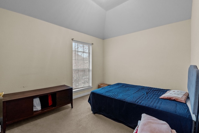 carpeted bedroom with lofted ceiling