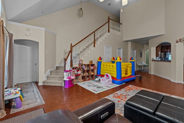 living room with hardwood / wood-style flooring and high vaulted ceiling