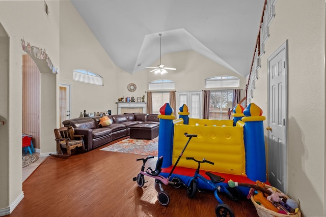 interior space featuring wood-type flooring, ceiling fan, and high vaulted ceiling