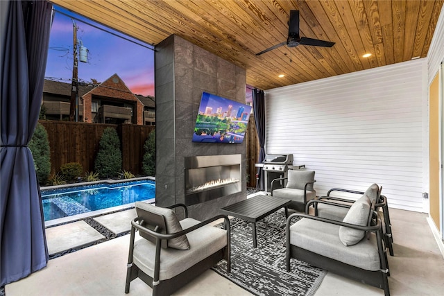 view of patio / terrace featuring a grill, a fireplace, a fenced in pool, and ceiling fan