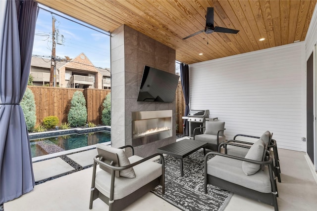 view of patio / terrace featuring ceiling fan, grilling area, a fireplace, and a fenced in pool