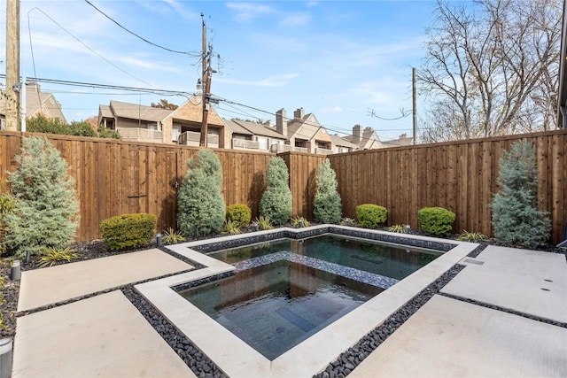 view of swimming pool with an in ground hot tub and a patio