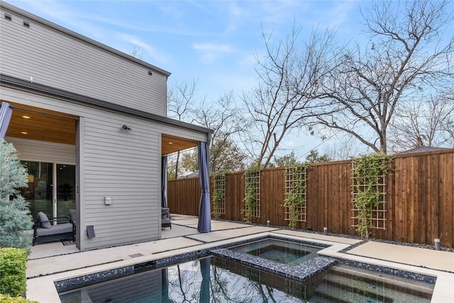 view of swimming pool featuring a patio and an in ground hot tub