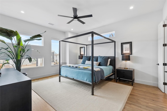 bedroom with light hardwood / wood-style floors and ceiling fan