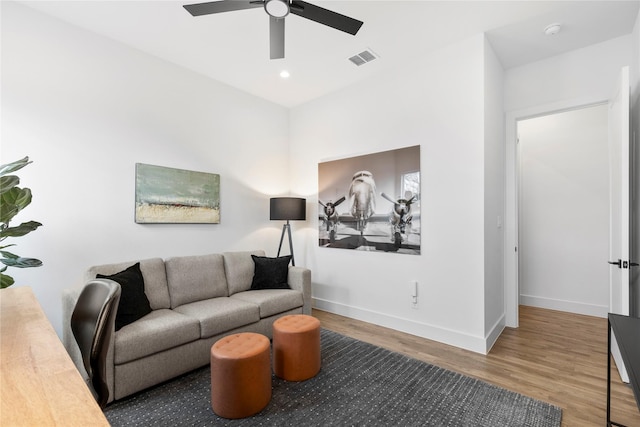 living room with hardwood / wood-style flooring and ceiling fan