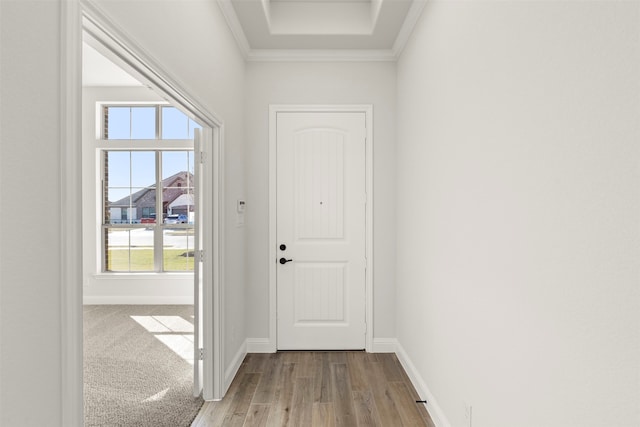 entryway featuring ornamental molding and light hardwood / wood-style flooring