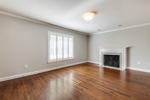 unfurnished living room with a tiled fireplace, crown molding, and dark wood-type flooring