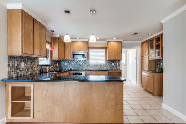 kitchen with appliances with stainless steel finishes, pendant lighting, light tile patterned floors, kitchen peninsula, and crown molding