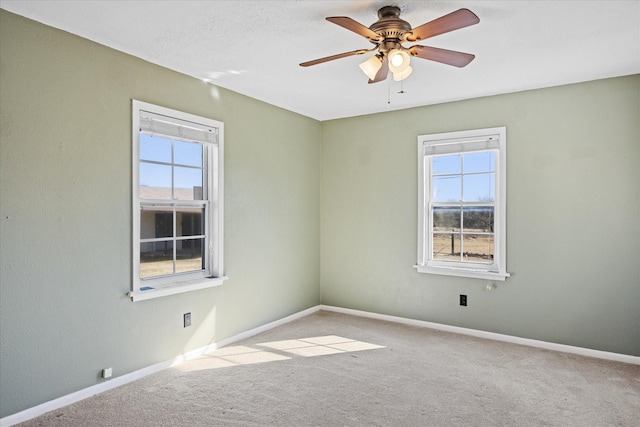 unfurnished room featuring light colored carpet and ceiling fan