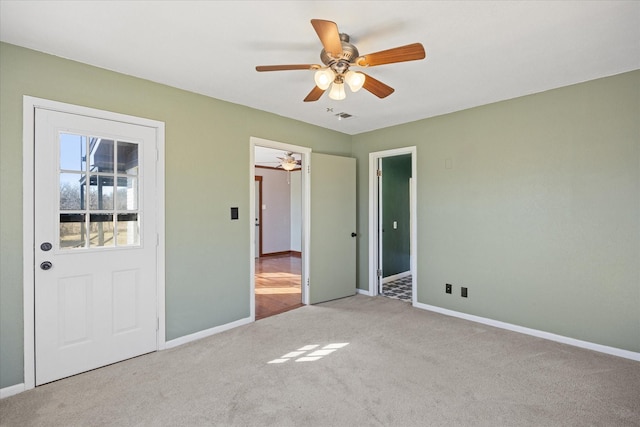 unfurnished bedroom featuring light colored carpet, ceiling fan, and a closet