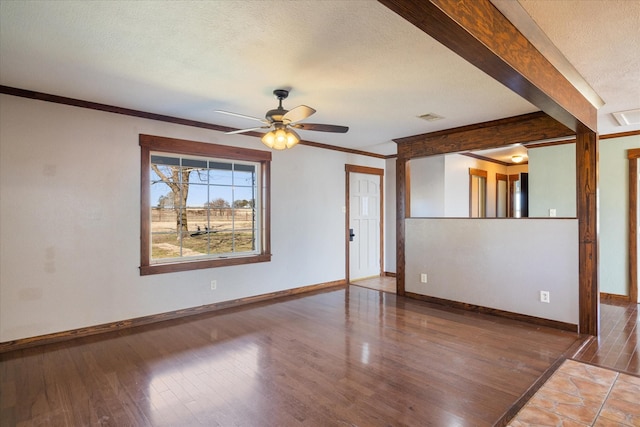 spare room featuring crown molding, a textured ceiling, ceiling fan, and hardwood / wood-style flooring