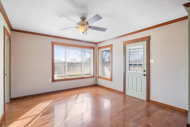 foyer featuring ornamental molding, ceiling fan, and light hardwood / wood-style floors