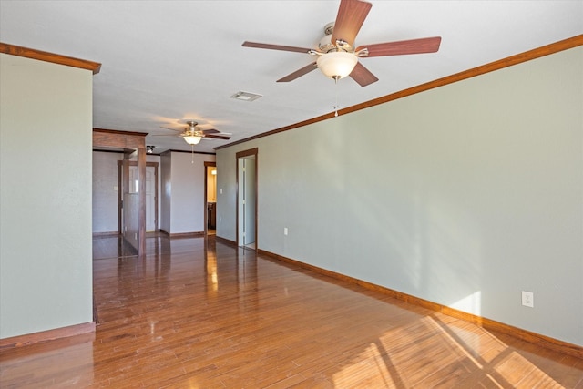 spare room with crown molding, ceiling fan, and hardwood / wood-style floors