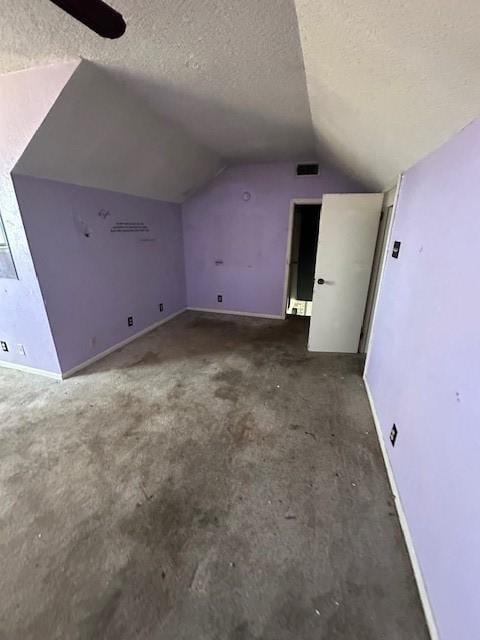 bonus room featuring vaulted ceiling and a textured ceiling