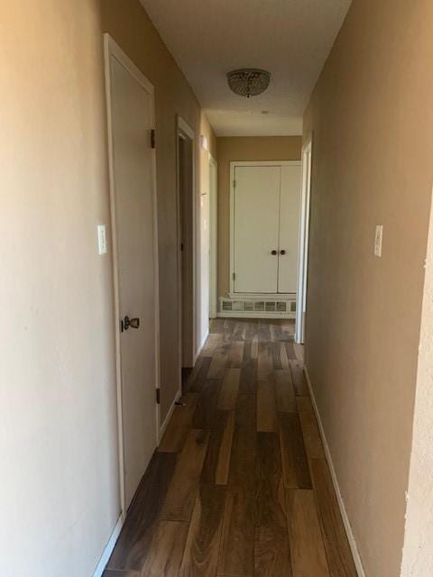 hallway with dark hardwood / wood-style floors