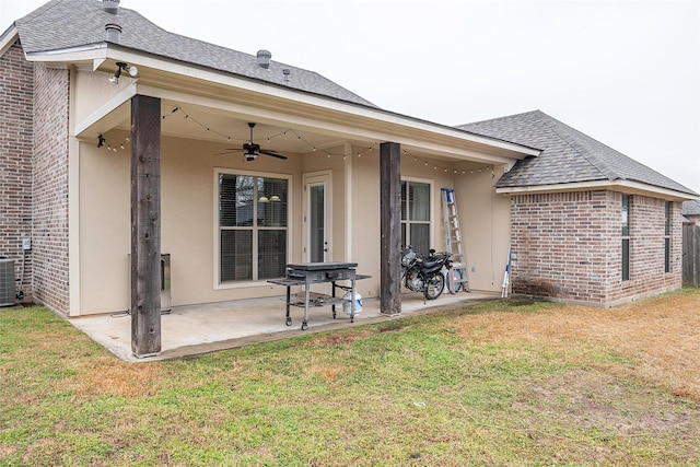 back of house featuring central AC unit, a lawn, a patio, and ceiling fan