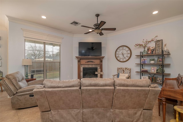 living room with ceiling fan, ornamental molding, and a brick fireplace