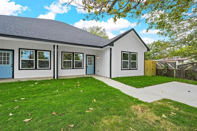 rear view of house with a yard