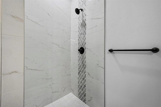 bathroom with tiled shower